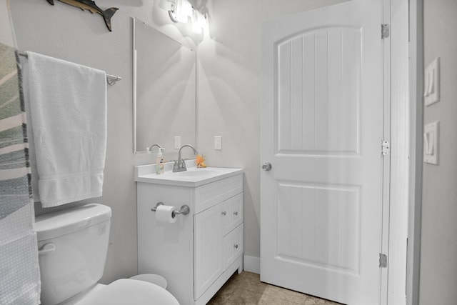 bathroom featuring tile patterned floors, vanity, and toilet