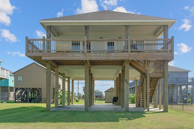 back of property featuring a lawn, a deck, and a patio