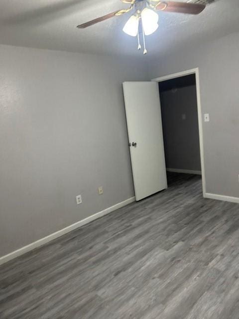 empty room featuring hardwood / wood-style flooring and ceiling fan