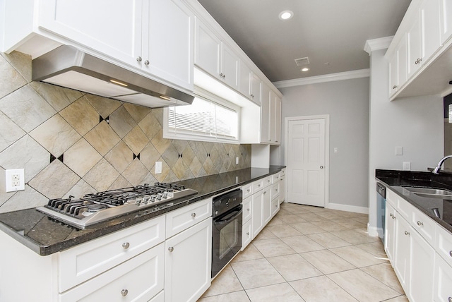 kitchen with crown molding, dark stone countertops, white cabinetry, and stainless steel appliances