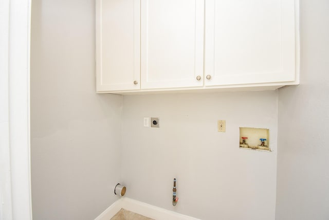 clothes washing area featuring washer hookup, electric dryer hookup, and cabinets