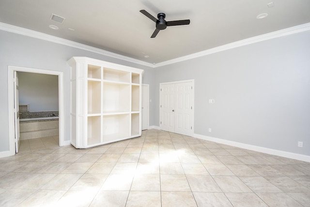 unfurnished bedroom featuring ceiling fan, light tile patterned floors, ensuite bathroom, and ornamental molding