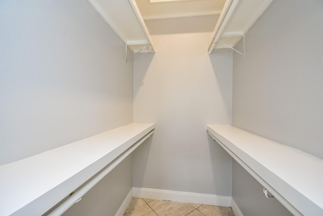 spacious closet with light tile patterned floors