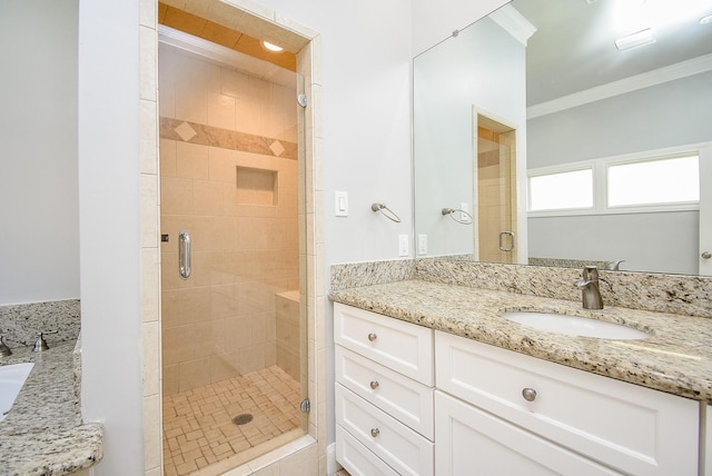 bathroom with vanity, a shower with door, and crown molding