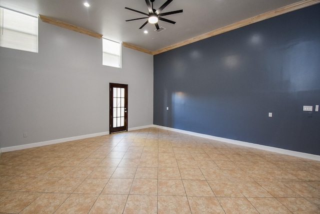 spare room featuring ceiling fan, crown molding, and light tile patterned flooring