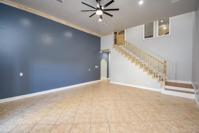 unfurnished living room with ceiling fan, crown molding, and light tile patterned flooring