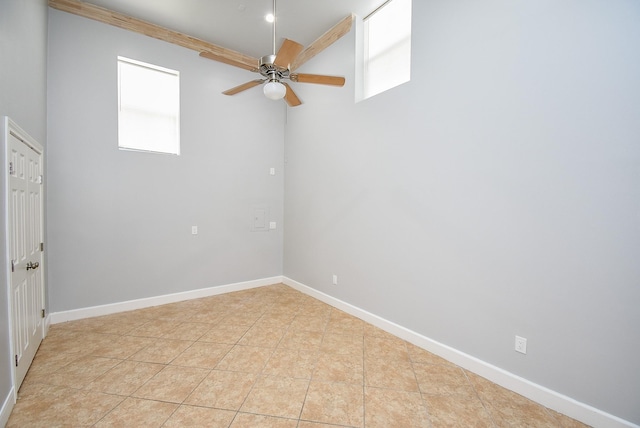 empty room featuring ceiling fan, a healthy amount of sunlight, and light tile patterned flooring