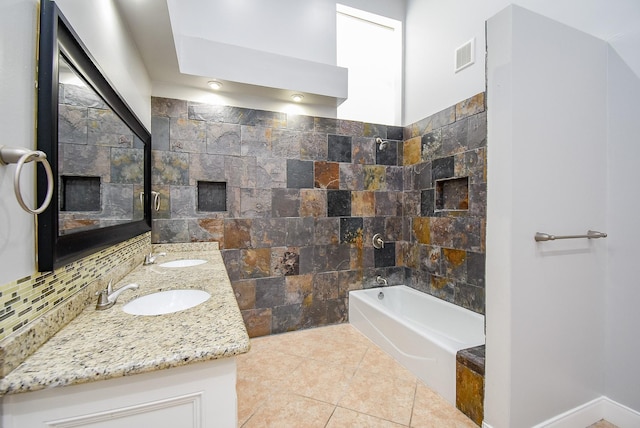 bathroom with decorative backsplash, vanity, tile patterned flooring, and a bathtub