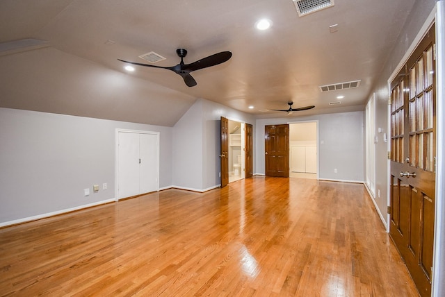 additional living space with ceiling fan, vaulted ceiling, and light wood-type flooring