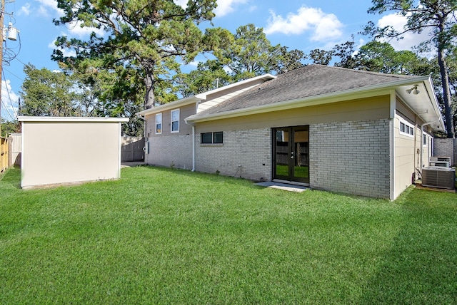 back of house featuring french doors and a yard