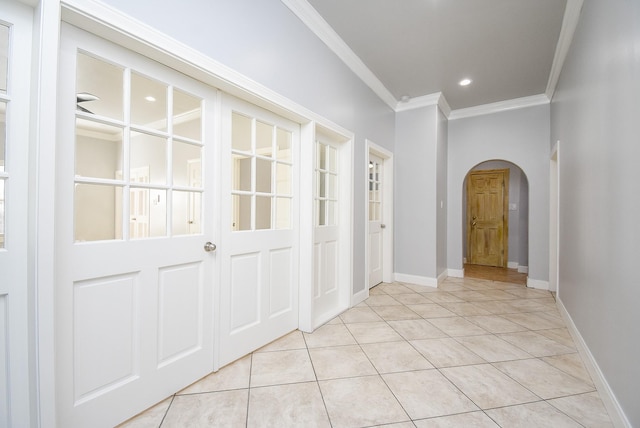 hall featuring ornamental molding and light tile patterned flooring