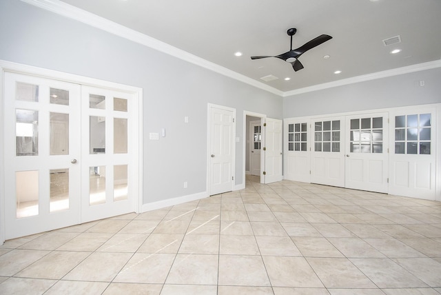 tiled empty room featuring ceiling fan and ornamental molding