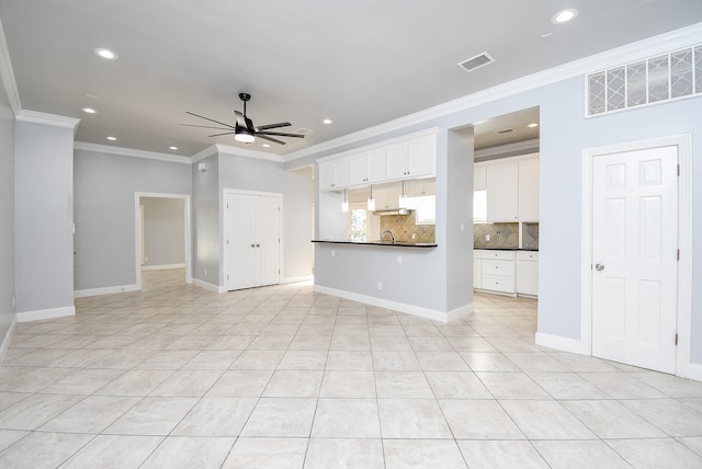 unfurnished living room featuring ceiling fan, ornamental molding, and light tile patterned floors