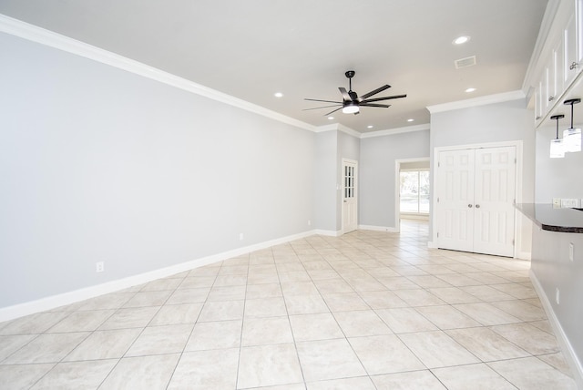 unfurnished room with ceiling fan, light tile patterned floors, and ornamental molding