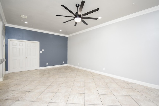 tiled spare room featuring ceiling fan and ornamental molding