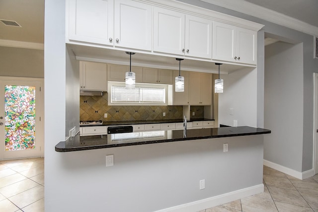 kitchen with white cabinets, decorative light fixtures, and tasteful backsplash