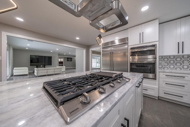 kitchen featuring white cabinetry, light stone countertops, and appliances with stainless steel finishes