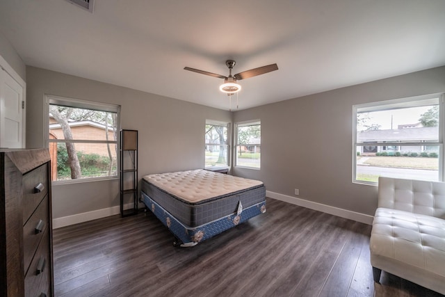 bedroom with ceiling fan and dark hardwood / wood-style floors