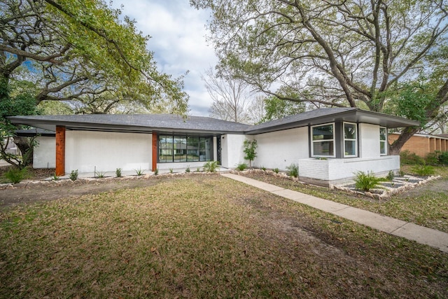 view of front of house with a front yard and a garage