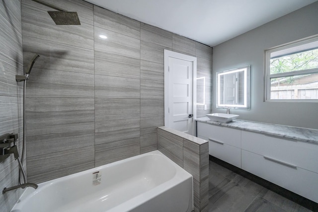 bathroom featuring vanity and tiled shower / bath combo