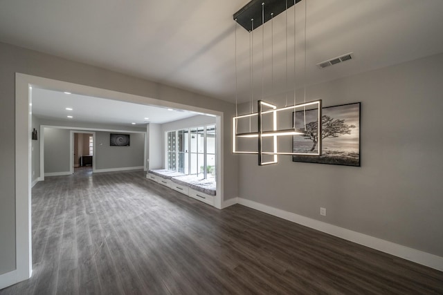 unfurnished living room with dark wood-type flooring