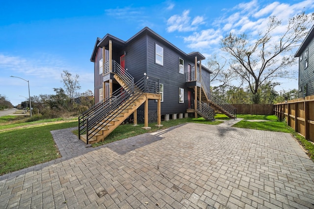 rear view of house with a yard and a patio