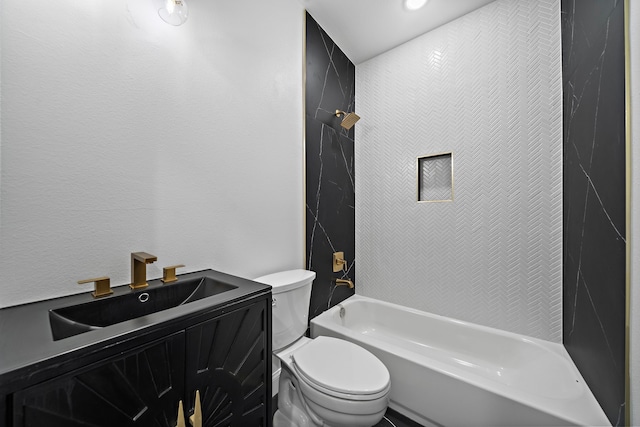 full bathroom featuring vanity, tiled shower / bath, and toilet