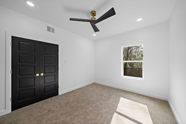 carpeted empty room with ceiling fan