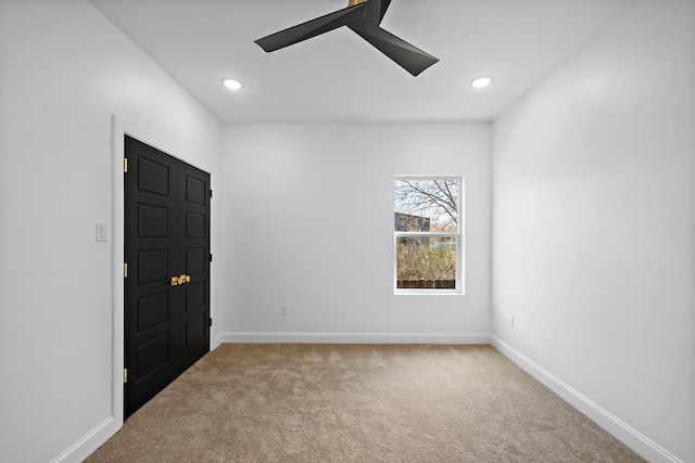 spare room with carpet flooring and ceiling fan