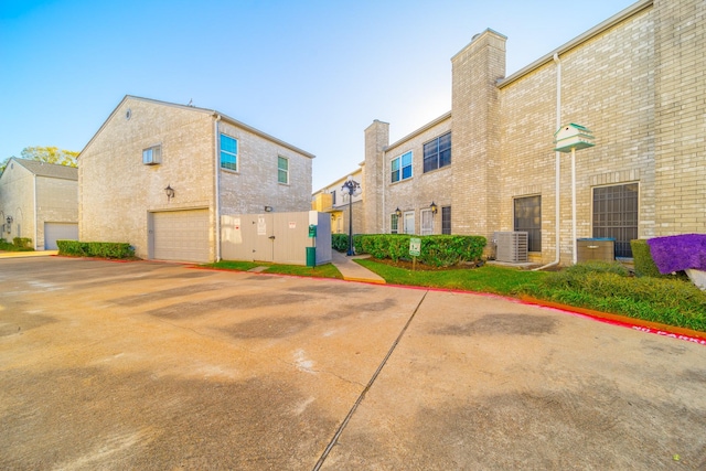 exterior space featuring central AC and a garage