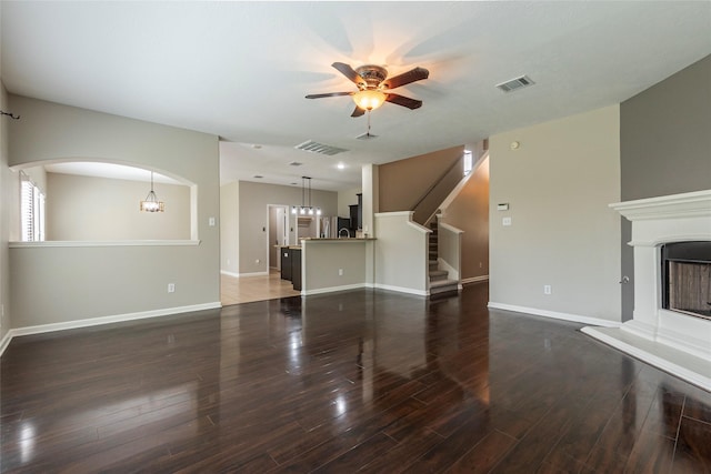 unfurnished living room with ceiling fan and dark hardwood / wood-style flooring