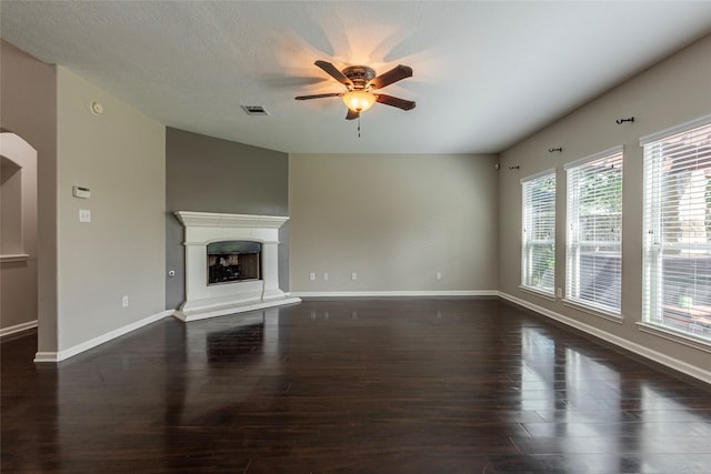 unfurnished living room with ceiling fan and dark hardwood / wood-style floors