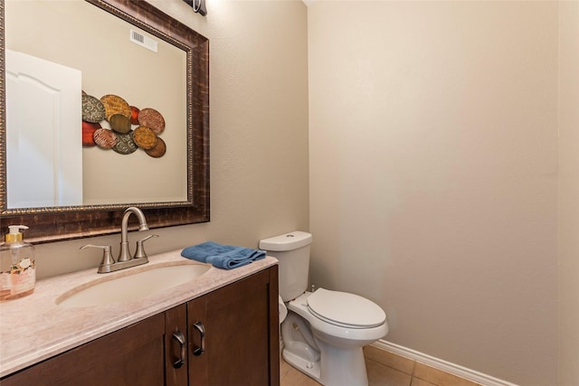 bathroom featuring tile patterned floors, vanity, and toilet