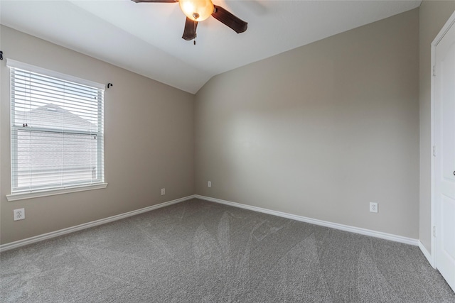 empty room featuring ceiling fan, carpet floors, and vaulted ceiling