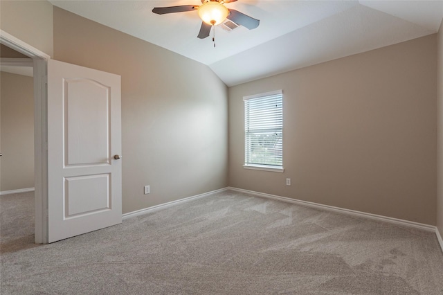 unfurnished room with ceiling fan, lofted ceiling, and light carpet