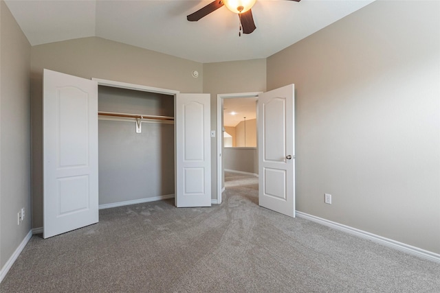 unfurnished bedroom featuring ceiling fan, a closet, carpet, and vaulted ceiling