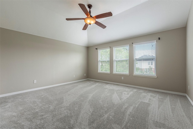 unfurnished room with light carpet, vaulted ceiling, and ceiling fan