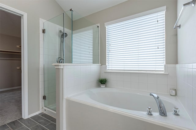 bathroom featuring tile patterned flooring and independent shower and bath