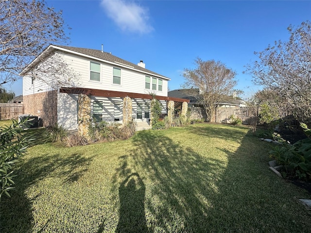 rear view of house with a yard