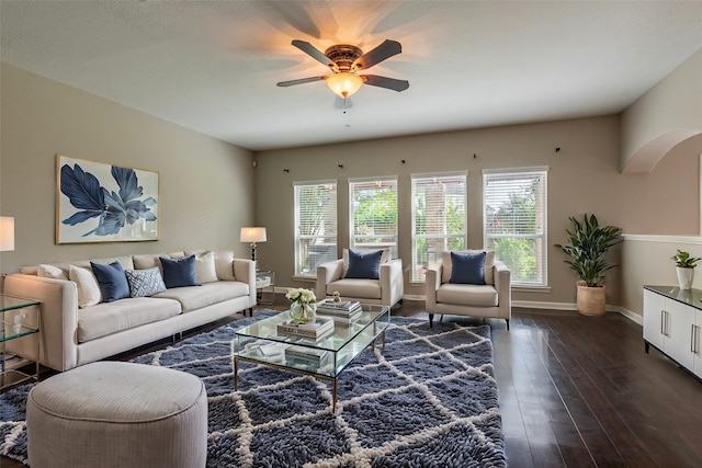 living room with ceiling fan and dark wood-type flooring