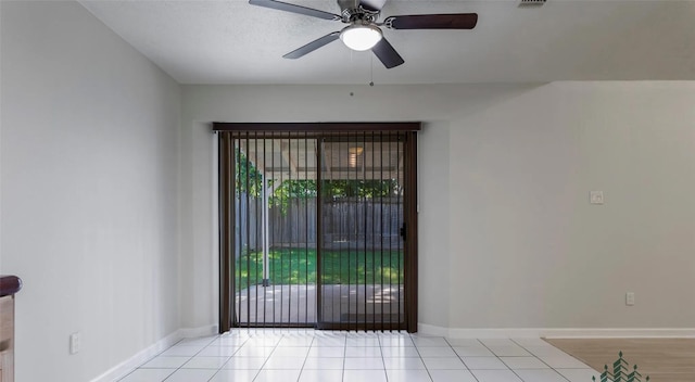 unfurnished room with ceiling fan and light tile patterned floors