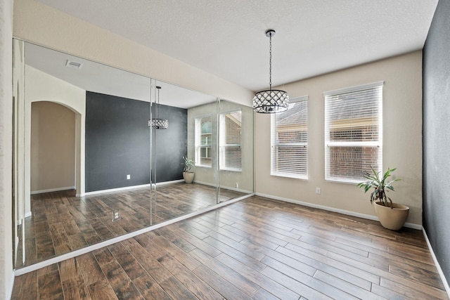 unfurnished dining area featuring a notable chandelier