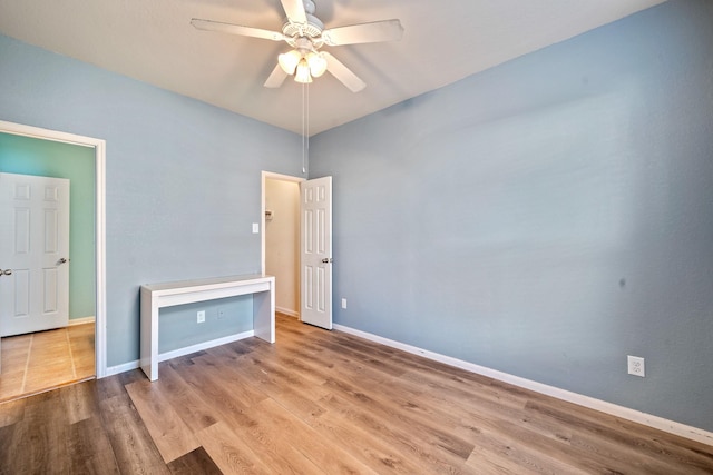 unfurnished bedroom with ceiling fan and light hardwood / wood-style flooring