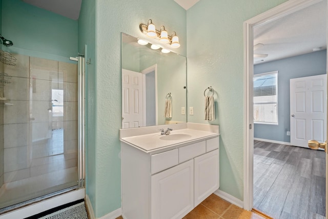 bathroom featuring vanity and an enclosed shower