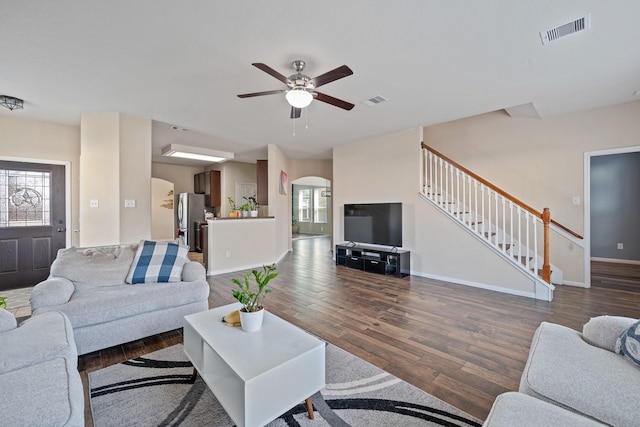 living room with ceiling fan and dark hardwood / wood-style flooring