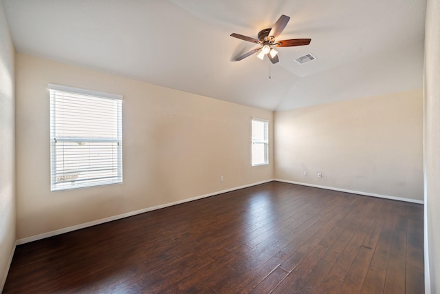 spare room featuring dark wood-type flooring, ceiling fan, and lofted ceiling