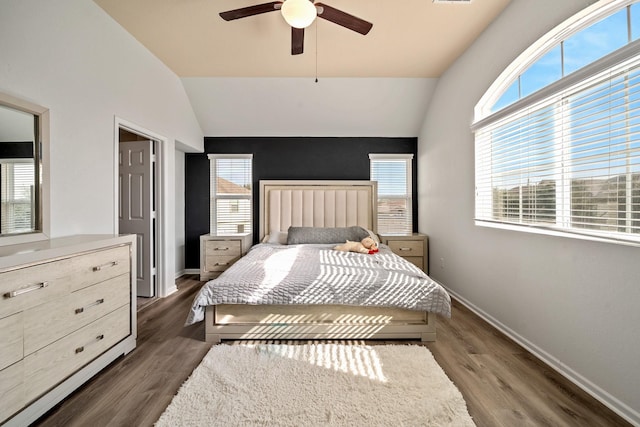 bedroom with ceiling fan, dark hardwood / wood-style flooring, and lofted ceiling