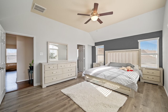 bedroom featuring ceiling fan, vaulted ceiling, and light hardwood / wood-style flooring