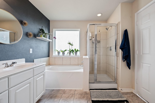 bathroom featuring tile patterned floors, vanity, and plus walk in shower