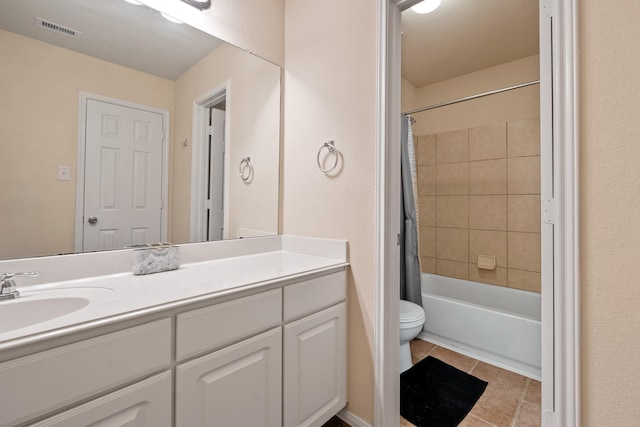 full bathroom featuring tile patterned floors, vanity, toilet, and shower / bath combo